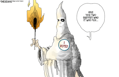 Klansman  holding torch and wearing an 