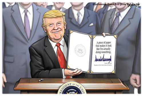 Trump displays signed executive order, which reads 